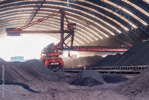 Canvas Print Industrial stacker reclaimer loading machine working within large indoor mining