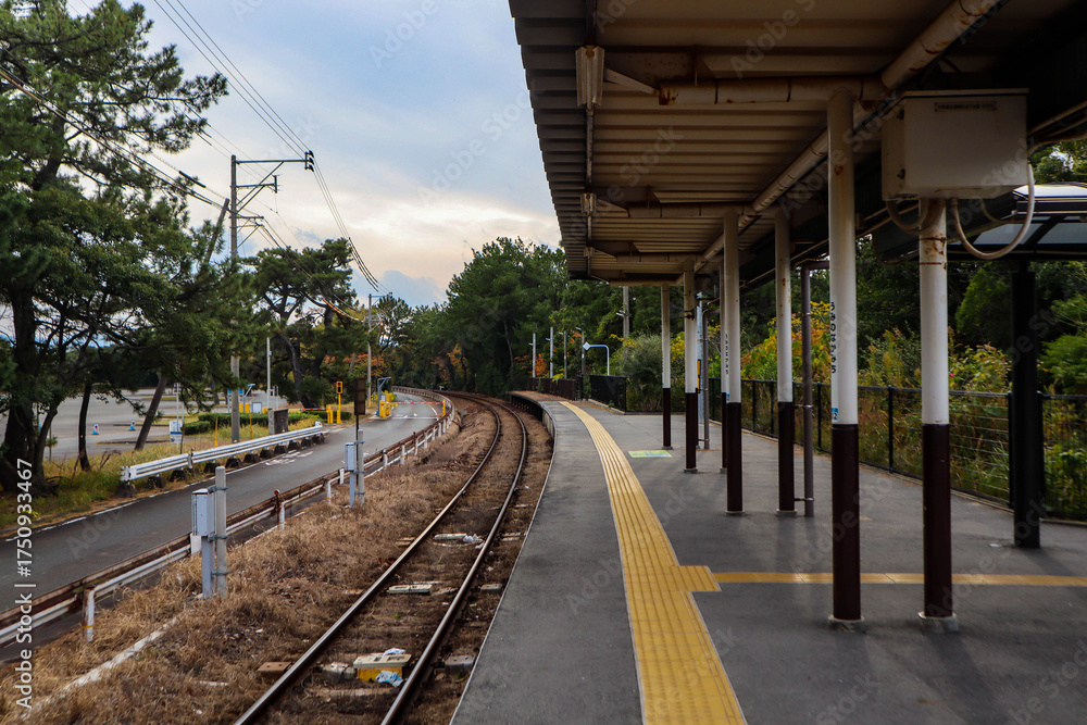 Fototapeta premium Empty Rural Japanese Train Platform and Curved Tracks.
