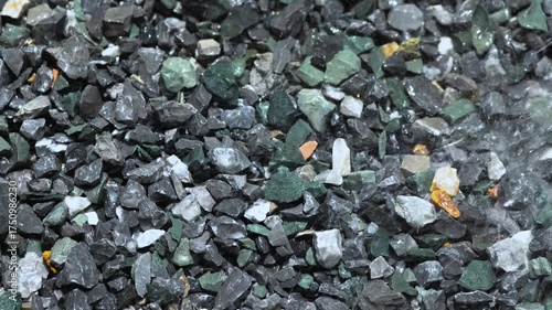 Watering construction stones for cement mixing, Rock, Stone pile, showing material preparation in construction work