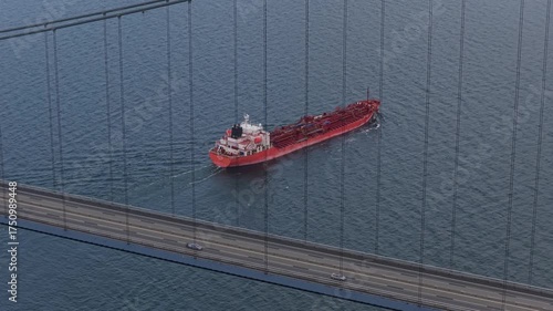 Drone perspective of Great Belt Bridge and petroleum tanker.
