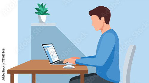 Man in a blue shirt working on a laptop at a wooden desk