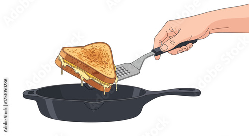 Grilled cheese sandwich being lifted from a skillet with a spatula.