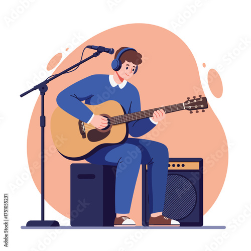 A young man plays an acoustic guitar while sitting on an amplifier, wearing headphones and singing into a microphone.
