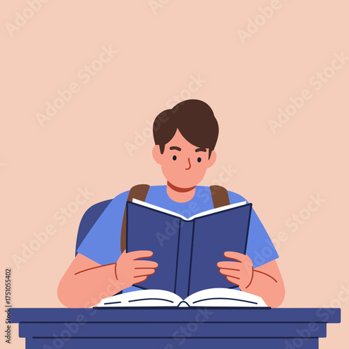A young student with a backpack is deeply engrossed in reading a large book at a desk.