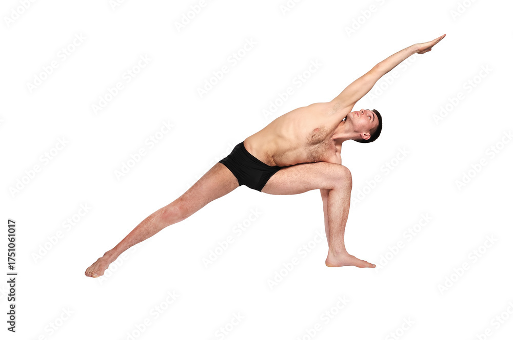 Fototapeta premium A man practices yoga by raising both arms up in a pose.
