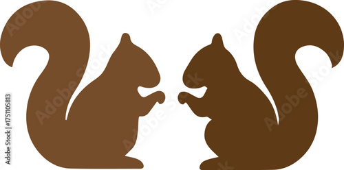 Two brown squirrels facing each other in silhouette.