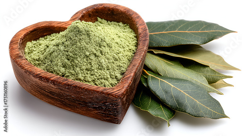 a rustic, heart-shaped wooden bowl filled with a light sage-green powder, likely ground bay leaves. Next to the bowl is a cluster of both fresh, deep-green and dried bay leaves