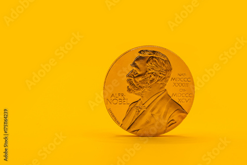 Fotografie The gold medal of the Nobel Prize laureate on a yellow background