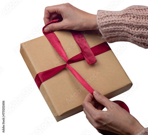 Christmas Gift wrapping in kraft paper. Gift wrapping in kraft paper. Females hands wrap boxes with gifts and tie bows made of bright ribbon