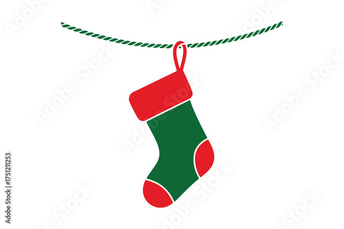 Green and red christmas stocking hanging on a twine string