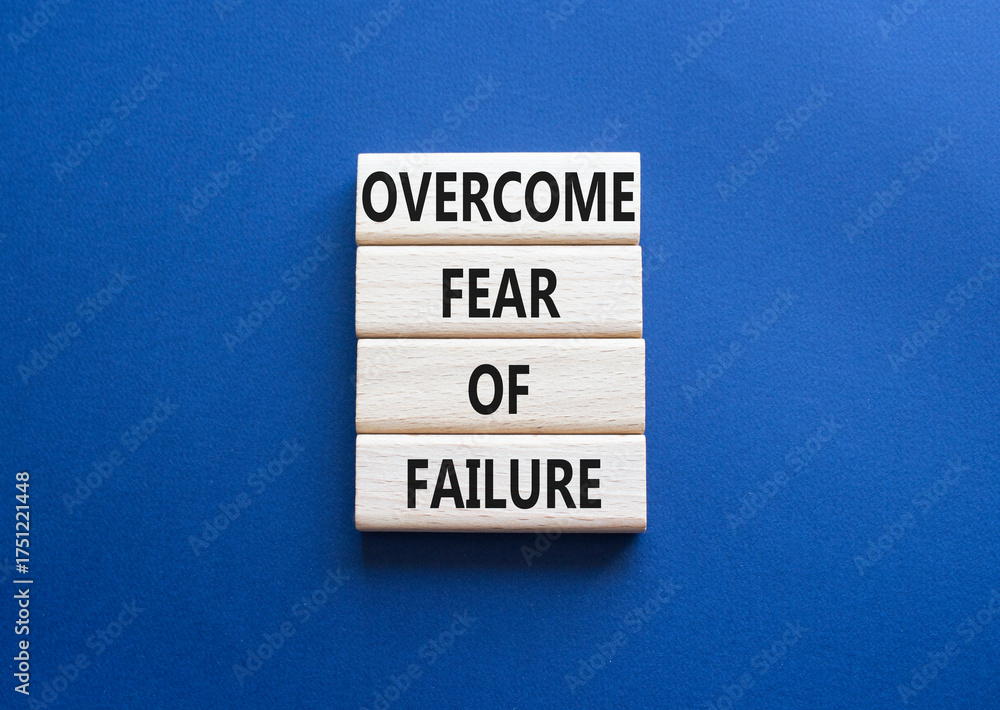 Obraz premium Fear of failure symbol. Concept words Overcome Fear of failure on wooden blocks. Beautiful deep blue background. Business and Fear of failure concept. Copy space.
