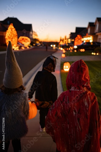 Children in costumes trick or treating on halloween night