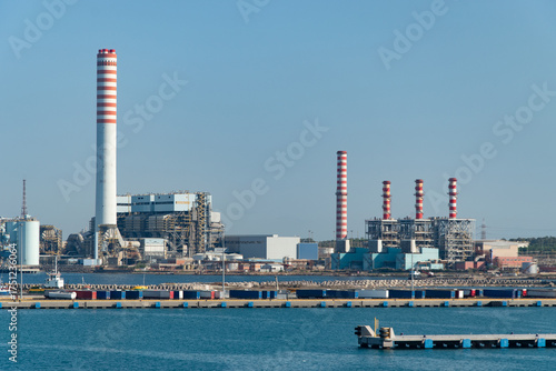 Bild auf Leinwand Coal-fired power plant with tall smokestacks in the port of Civitavecchia, Italy