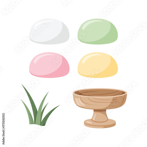 Colorful mochi desserts arranged with grass and a wooden stand
