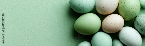 Colorful Decorative Eggs Arranged on Soft Green Surface for Spring Celebration