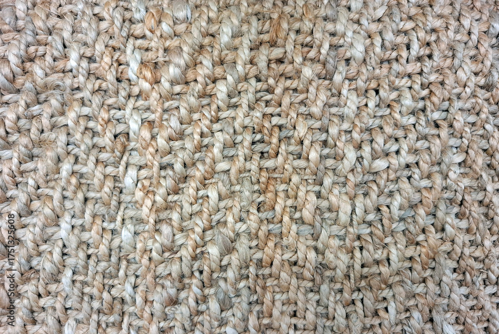 Fototapeta premium Large weave jute carpet displays intricate texture and natural tones for modern interior design