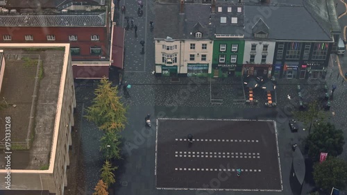Aerial view of Liverpool city streets on a rainy autumn day. People move slowly through the wet roads, creating a moody, cinematic atmosphere. Horizontal footage perfect for urban storytelling