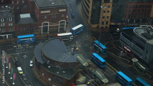 Drone footage of Liverpool city under light rain on an autumn day. Buses and cars move through wet roads, reflecting soft light. A melancholic yet peaceful mood, ideal for creative projects, branding 