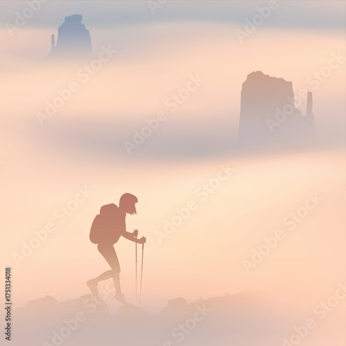 Hiking with trekking poles. Woman at mountain range. Silhouette in fog