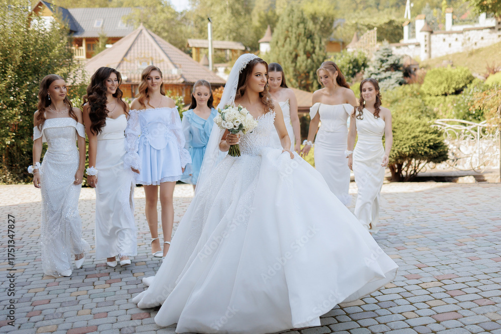 Fototapeta premium Bridal party walking together in a beautiful outdoor setting during a wedding celebration