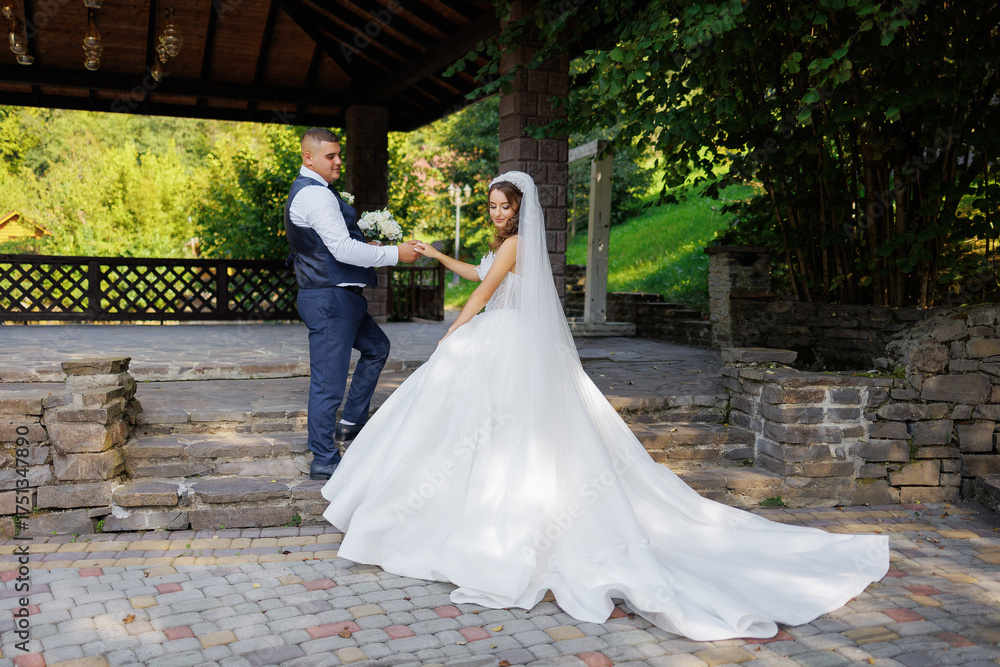 Fototapeta premium Couple exchanges vows in a scenic outdoor setting on their wedding day