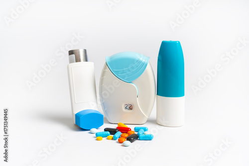 Set of asthma bronchodilators, inhalers for asthma and COPD patients and capsules, pills on white background. 