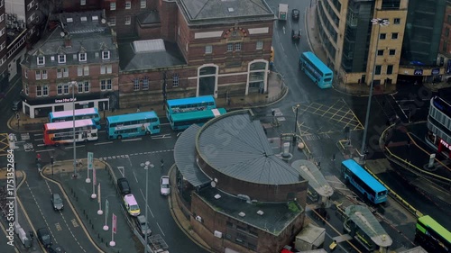 Drone footage of Liverpool city under light rain on an autumn day. Buses and cars move through wet roads, reflecting soft light. A melancholic yet peaceful mood, ideal for creative projects, branding 