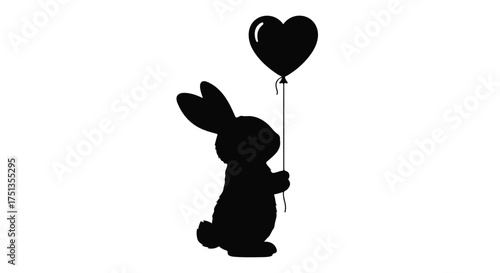 Silhouette of a playful rabbit holding a black heart-shaped balloon