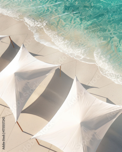 Aerial view of white beach umbrellas on sandy shore with turquoise water at tropical resort