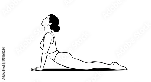 Woman gracefully performs upward-facing dog yoga pose with serene expression