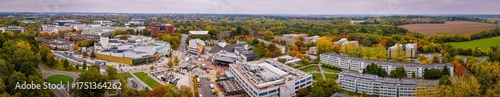 Aerial view of the University of Warwick campus surrounded by trees in autumn colors