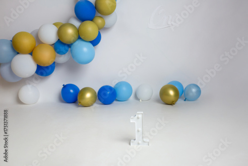 First Birthday Celebration Studio Setup with Blue and Gold Balloons