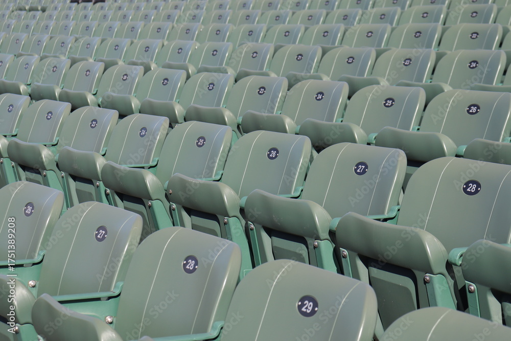 Naklejka premium Rows of seats in stadium and outdoor event in summer. Outdoor architecture and exterior amphitheater with green seats. Seats design and public stadium. Outdoor show in summer.