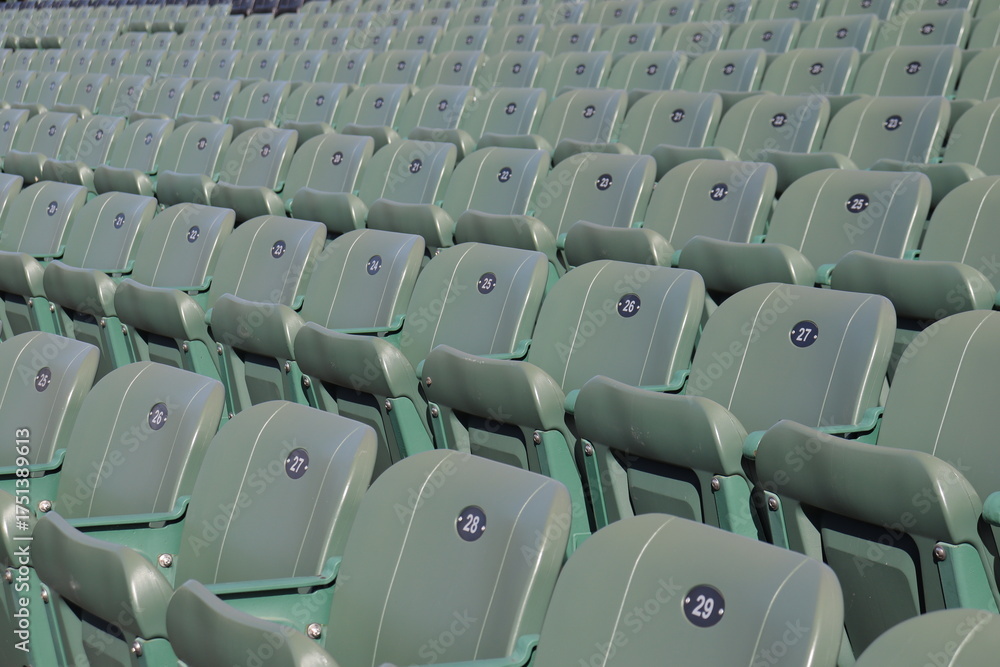Fototapeta premium Rows of seats in stadium and outdoor event in summer. Outdoor architecture and exterior amphitheater with green seats. Seats design and public stadium. Outdoor show in summer.