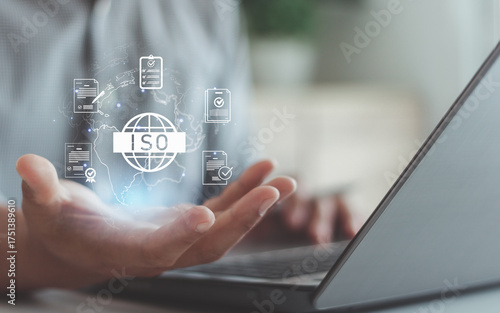 Businessman showing ISO certification hologram concept for quality management, international standards, compliance system, global business assurance, accreditation and quality control technology.