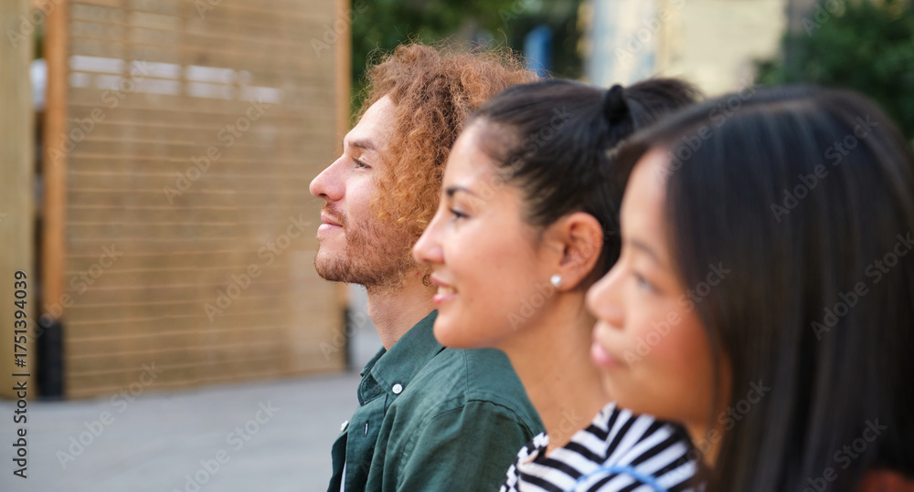 Fototapeta premium Three young professionals looking up at something with hope and expectation