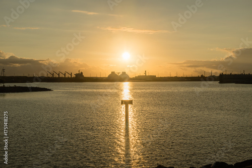 Sun rising over the oil refinery on west Oahu, Hawaii 