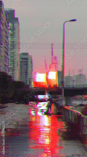 Urban landscape with neon reflections on wet pavement at dusk  