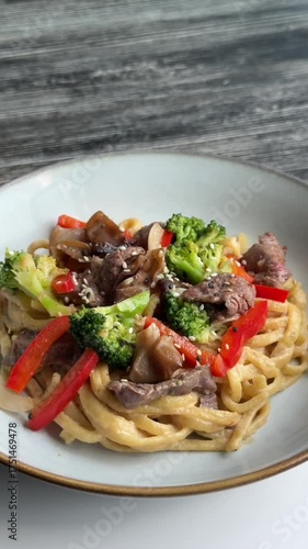 Top view of pasta with beef and broccoli. 