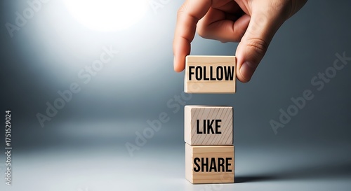 Hand stacking wooden blocks with the words follow, like, and share, representing social media engagement