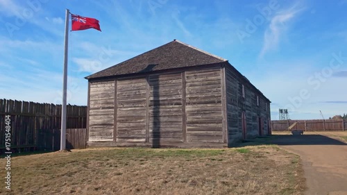 A scenic view of Fort Vancouver, a former fur trading post, showcasing its reconstructed stockade and historical buildings under a clear sky