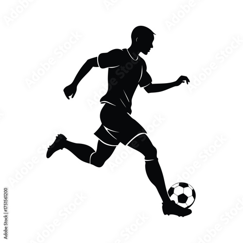 Silhouette of a soccer player kicking a ball football