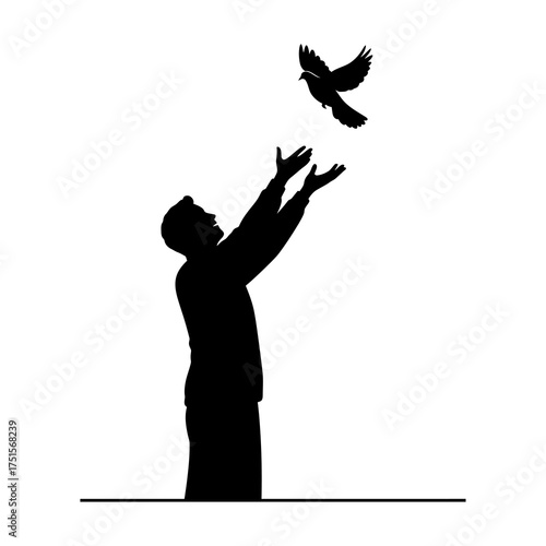 Silhouette of a man releasing a bird into the air, symbolizing freedom.