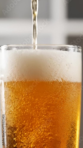 Pouring Refreshing Lager Into Glass Creating Foam Head Close Up