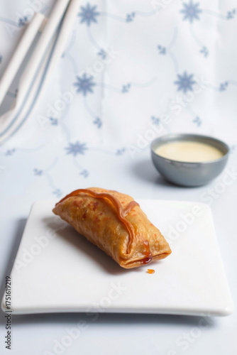 A Samosa Golden Fried On A White Background