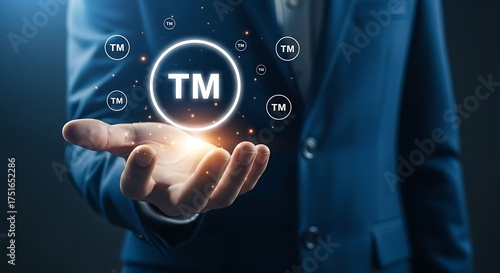 Hand holding glowing trademark symbol brand logo