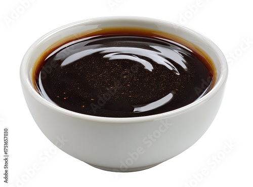 Dark brown sauce in a small, white bowl