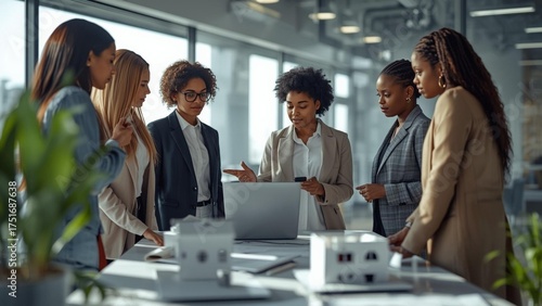 Diverse team collaborating on project, analyzing data and discussing business strategies in modern office