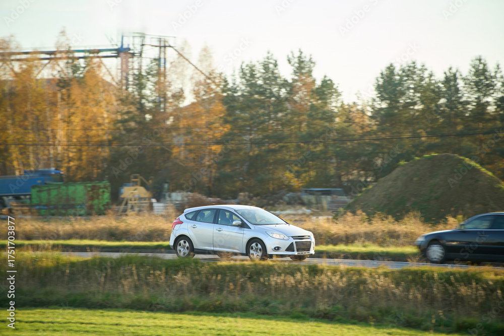 Fototapeta premium Compact eco-friendly car in autumn nature