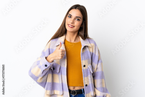 Young caucasian woman isolated on purple background giving a thumbs up gesture